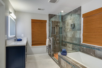 Example of a mid-sized minimalist master gray tile and porcelain tile porcelain tile and gray floor bathroom design in DC Metro with shaker cabinets, blue cabinets, a two-piece toilet, gray walls, an undermount sink, quartz countertops and a hinged shower door