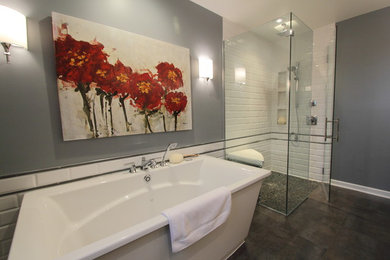 Example of a large transitional master white tile and subway tile ceramic tile and brown floor bathroom design in New York with gray walls and a hinged shower door