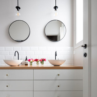 Inspiration for a contemporary bathroom in Melbourne with flat-panel cabinets, white cabinets, white tile, subway tile, grey walls, mosaic tile floors, a vessel sink, wood benchtops, multi-coloured floor and brown benchtops.