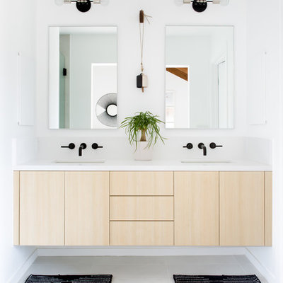 Example of a mid-sized danish master white tile ceramic tile and white floor bathroom design in Los Angeles with flat-panel cabinets, light wood cabinets, white walls, an undermount sink, quartz countertops and a hinged shower door