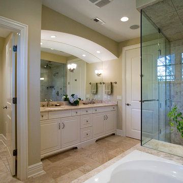 Limestone Tile Master Bathroom with White Brookhaven Cabinetry