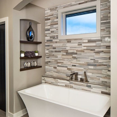 Freestanding bathtub - contemporary master beige tile and gray tile freestanding bathtub idea in Omaha with gray walls