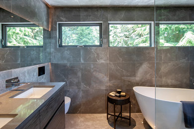 Example of a mid-sized trendy 3/4 gray tile and ceramic tile gray floor and ceramic tile bathroom design in Vancouver with gray cabinets, a one-piece toilet, gray walls, an undermount sink, gray countertops and flat-panel cabinets