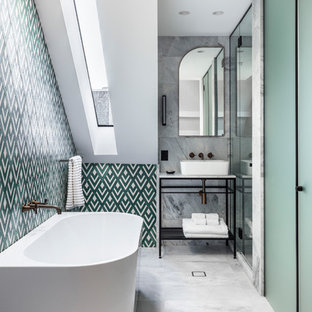 This is an example of a transitional bathroom in Sydney with a freestanding tub, multi-coloured tile, white walls, a vessel sink and grey floor.