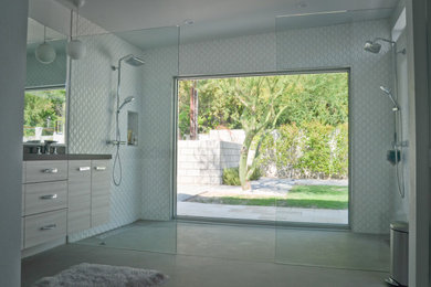 Large 1960s master white tile and porcelain tile concrete floor and gray floor bathroom photo in Other with flat-panel cabinets, light wood cabinets, a one-piece toilet, white walls, an undermount sink, granite countertops and black countertops