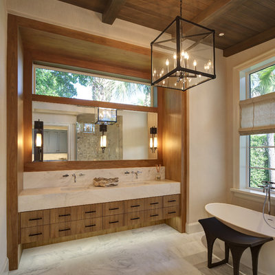 Inspiration for a huge contemporary master stone tile, gray tile and white tile marble floor and white floor freestanding bathtub remodel in Cleveland with flat-panel cabinets, medium tone wood cabinets, an undermount sink, marble countertops, beige walls and white countertops