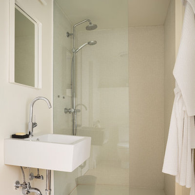 Example of a mountain style 3/4 light wood floor alcove shower design in Portland Maine with a wall-mount sink and white walls