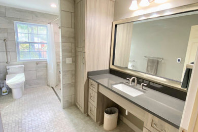 Inspiration for a mid-sized transitional master gray tile and porcelain tile mosaic tile floor, gray floor and single-sink bathroom remodel in Other with shaker cabinets, gray cabinets, a bidet, gray walls, an undermount sink, quartz countertops, gray countertops, a niche and a built-in vanity