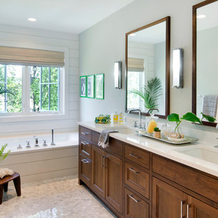 Bathroom - transitional mosaic tile floor bathroom idea in Minneapolis with recessed-panel cabinets, dark wood cabinets, an undermount tub, green walls and an undermount sink