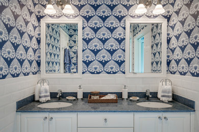 Example of a mid-sized beach style master white tile and subway tile ceramic tile and white floor bathroom design in New York with raised-panel cabinets, white cabinets, a one-piece toilet, blue walls and an undermount sink