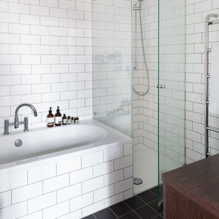 Inspiration for a mid-sized scandinavian master white tile and subway tile slate floor bathroom remodel in London with dark wood cabinets, wood countertops and white walls
