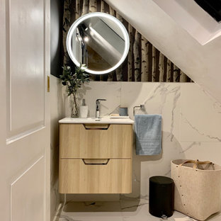 Design ideas for a medium sized contemporary family bathroom in London with flat-panel cabinets, light wood cabinets, black and white tiles, porcelain tiles, black walls, porcelain flooring, solid surface worktops, white floors, an integrated sink and white worktops.