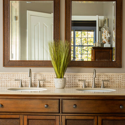 Bathroom - tropical beige tile and mosaic tile bathroom idea in Charlotte with an undermount sink, shaker cabinets and gray walls