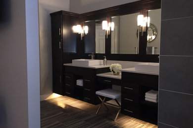 Example of a large trendy master gray tile porcelain tile and brown floor bathroom design in Other with dark wood cabinets, a vessel sink, quartz countertops and gray walls