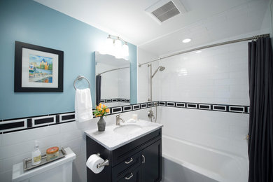 Example of a small transitional kids' black and white tile and ceramic tile mosaic tile floor and black floor bathroom design in Boston with recessed-panel cabinets, black cabinets, a one-piece toilet, blue walls, an undermount sink and granite countertops