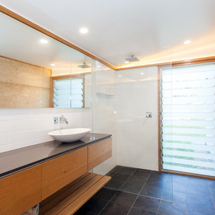 Photo of a mid-sized modern master bathroom in Central Coast with furniture-like cabinets, light wood cabinets, an open shower, white tile, stone tile, white walls, slate floors, a vessel sink, engineered quartz benchtops, black floor, an open shower and black benchtops.