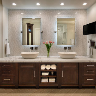 Classic bathroom in San Francisco with a vessel sink, recessed-panel cabinets, dark wood cabinets and white tiles.