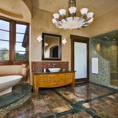 Freestanding bathtub - rustic mosaic tile freestanding bathtub idea in Austin with a vessel sink