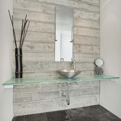 Inspiration for a contemporary black floor bathroom remodel in San Francisco with a vessel sink and turquoise countertops