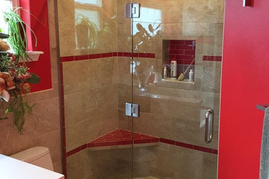 Inspiration for a mid-sized transitional beige tile and porcelain tile alcove shower remodel in Seattle with a two-piece toilet and red walls