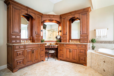Photo of a large mediterranean sauna bathroom in Philadelphia with a submerged sink, freestanding cabinets, medium wood cabinets, granite worktops, a two-piece toilet, beige tiles, porcelain tiles, beige walls, porcelain flooring and a built-in bath.