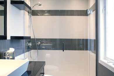 Mid-sized minimalist 3/4 white tile and porcelain tile porcelain tile and black floor walk-in shower photo in Toronto with a vessel sink, flat-panel cabinets, dark wood cabinets, quartz countertops, a one-piece toilet, gray walls and black countertops