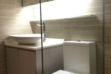 Mid-sized trendy beige tile and porcelain tile porcelain tile bathroom photo in Singapore with beige walls and a vessel sink