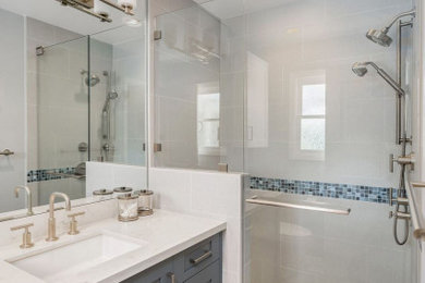 Inspiration for a small transitional kids' white tile and porcelain tile porcelain tile and brown floor doorless shower remodel in San Francisco with shaker cabinets, blue cabinets, an undermount sink, quartz countertops, a hinged shower door and white countertops