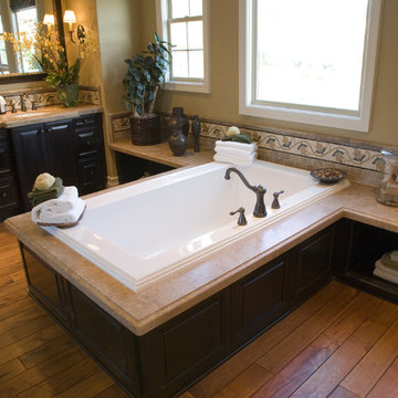 Luxurious bathroom with a modern tub and hardwood floor.