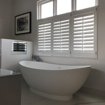 Luxurious large bathroom with TV in Putney