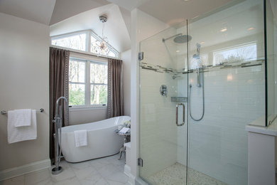 Example of a transitional white tile and subway tile ceramic tile bathroom design in Wilmington with an undermount sink, shaker cabinets, white cabinets, quartz countertops, a two-piece toilet and gray walls