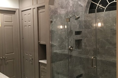 Double shower - mid-sized transitional master gray tile and marble tile marble floor and white floor double shower idea in Houston with shaker cabinets, gray cabinets, a one-piece toilet, gray walls, an undermount sink, marble countertops, a hinged shower door and white countertops