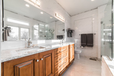 Expansive classic ensuite bathroom in Chicago with freestanding cabinets, medium wood cabinets, a submerged bath, a built-in shower, a one-piece toilet, multi-coloured tiles, ceramic tiles, multi-coloured walls, porcelain flooring, a submerged sink, engineered stone worktops, multi-coloured floors, a hinged door and multi-coloured worktops.