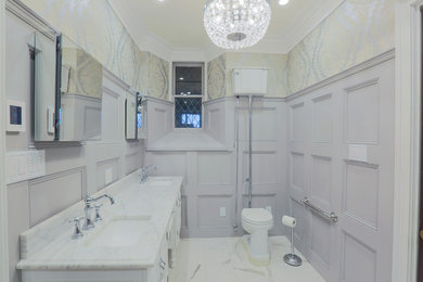 Example of a mid-sized transitional master ceramic tile and white floor alcove shower design in Baltimore with furniture-like cabinets, white cabinets, a two-piece toilet, gray walls, an undermount sink, marble countertops and a hinged shower door