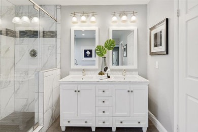 Example of a mid-sized classic master gray tile and marble tile ceramic tile and gray floor bathroom design in San Francisco with shaker cabinets, white cabinets, gray walls, an undermount sink, marble countertops, a hinged shower door and gray countertops