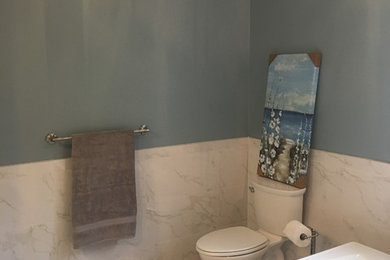 This is an example of a large contemporary ensuite bathroom in Richmond with raised-panel cabinets, white cabinets, a freestanding bath, an alcove shower, a one-piece toilet, white tiles, porcelain tiles, blue walls, porcelain flooring, a submerged sink, granite worktops, grey floors and a hinged door.