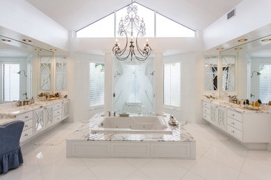 Elegant master bathroom photo in Miami with flat-panel cabinets, white cabinets, marble countertops and white walls