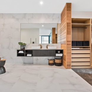 This is an example of a contemporary master bathroom in Perth with flat-panel cabinets, grey cabinets, a freestanding tub, gray tile, white tile, grey walls, a vessel sink, white floor and white benchtops.