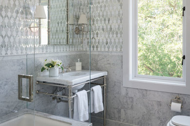 Elegant white tile and mosaic tile marble floor tub/shower combo photo in Seattle with marble countertops, an undermount tub and an undermount sink