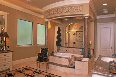 Large elegant master beige tile and porcelain tile porcelain tile corner shower photo in Houston with a drop-in sink, furniture-like cabinets, light wood cabinets, granite countertops, a hot tub, a one-piece toilet and black walls