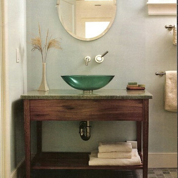 Mahogany vanity with green vessel sink