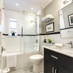 Photo of a small contemporary 3/4 bathroom in Other with shaker cabinets, dark wood cabinets, an alcove tub, a shower/bathtub combo, white tile, grey walls, marble benchtops, a two-piece toilet, subway tile, linoleum floors and a trough sink.