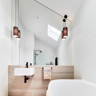 Photo of a mid-sized contemporary master bathroom in Melbourne with white cabinets, beige tile, stone tile, cement tiles, a wall-mount sink, beige floor, an open shower, a single vanity and white walls.