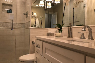 Mid-sized trendy white tile and subway tile mosaic tile floor and gray floor bathroom photo in Chicago with shaker cabinets, white cabinets, white countertops, an undermount sink, a two-piece toilet and white walls