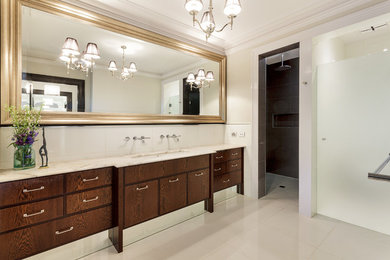 Large contemporary bathroom in Melbourne with dark wood cabinets, a walk-in shower, white walls and ceramic flooring.