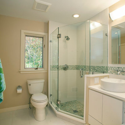 Corner shower - mid-sized traditional master green tile and ceramic tile ceramic tile and white floor corner shower idea in Philadelphia with a vessel sink, flat-panel cabinets, white cabinets, beige walls and a two-piece toilet