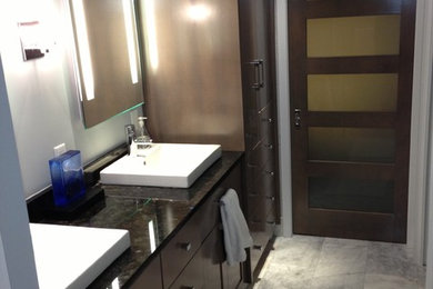 Example of a mid-sized trendy master marble floor and gray floor bathroom design in Jacksonville with shaker cabinets, dark wood cabinets, gray walls and a vessel sink