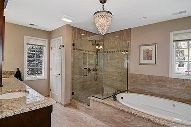 Bathroom - mid-sized contemporary 3/4 beige tile and stone slab ceramic tile and beige floor bathroom idea in Chicago with flat-panel cabinets, dark wood cabinets, a one-piece toilet, beige walls, a drop-in sink, solid surface countertops and a hinged shower door