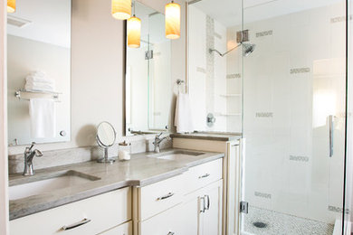 This is an example of a contemporary bathroom in Minneapolis with shaker cabinets, white cabinets, a corner shower, grey tiles, ceramic tiles, ceramic flooring, a submerged sink and marble worktops.
