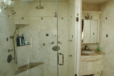 Corner shower - traditional white tile and stone slab corner shower idea in New York with a console sink and granite countertops